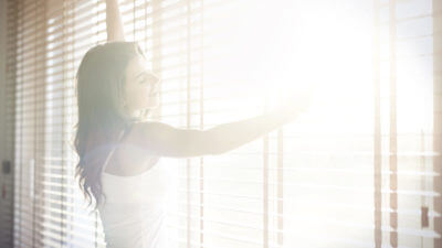Window Coverings for Your Sunroom - girl at sunny window